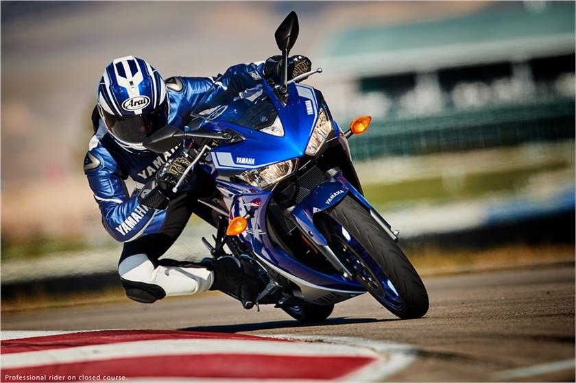 Racer in blue gear speeding towards camera on R3