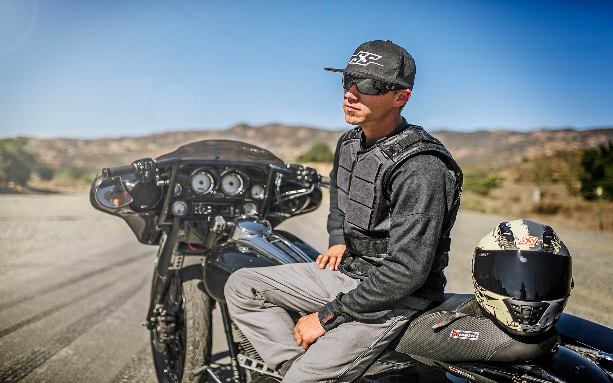 Rider wearing long sleeves and armored vest while sitting on bike