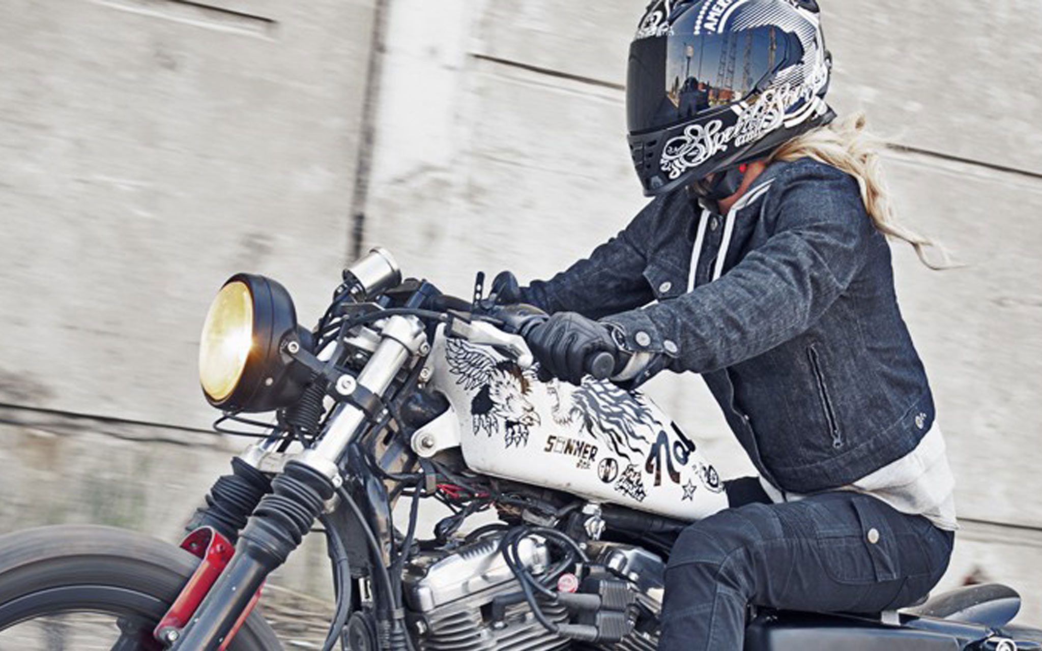 Woman riding a motorcycle in full gear