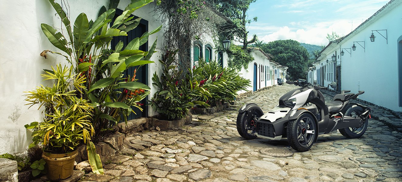 white Can Am Ryker parked on cobblestone street