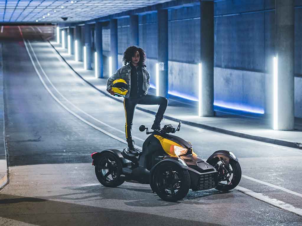 rider standing confidently on yellow and black Can Am Ryker in road tunnel