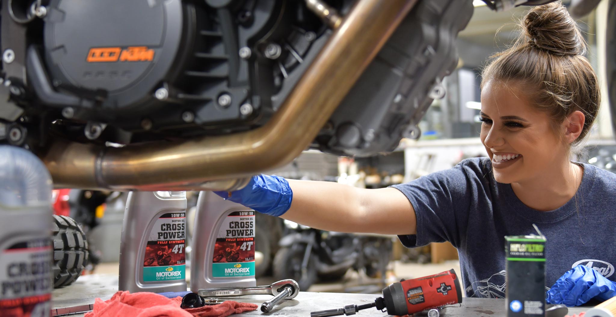 Service technician changing oil on motorcycle