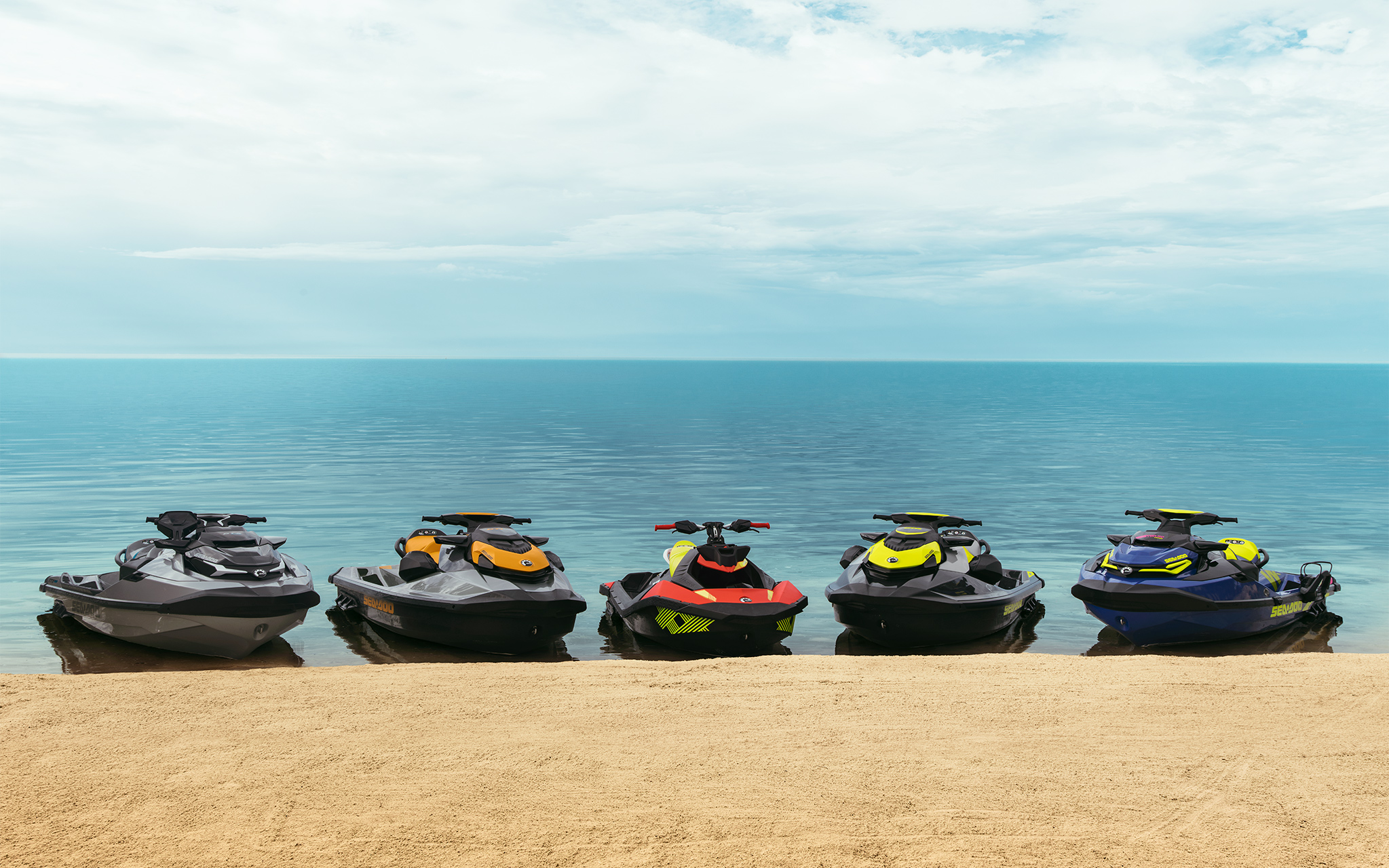 line-up of various watercraft parked on beach