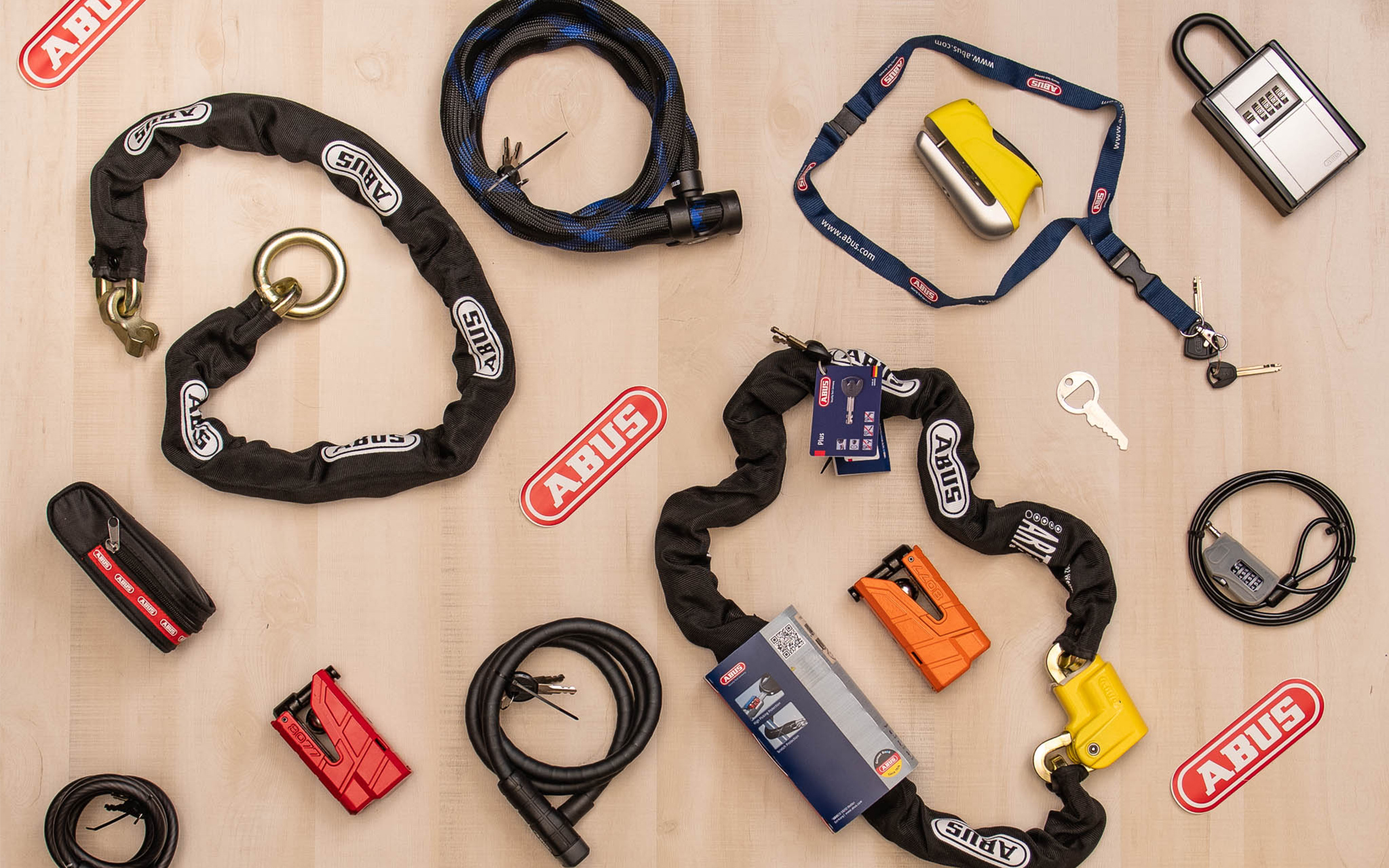 Stock photo of various Abus locks and chains displayed on wooden board