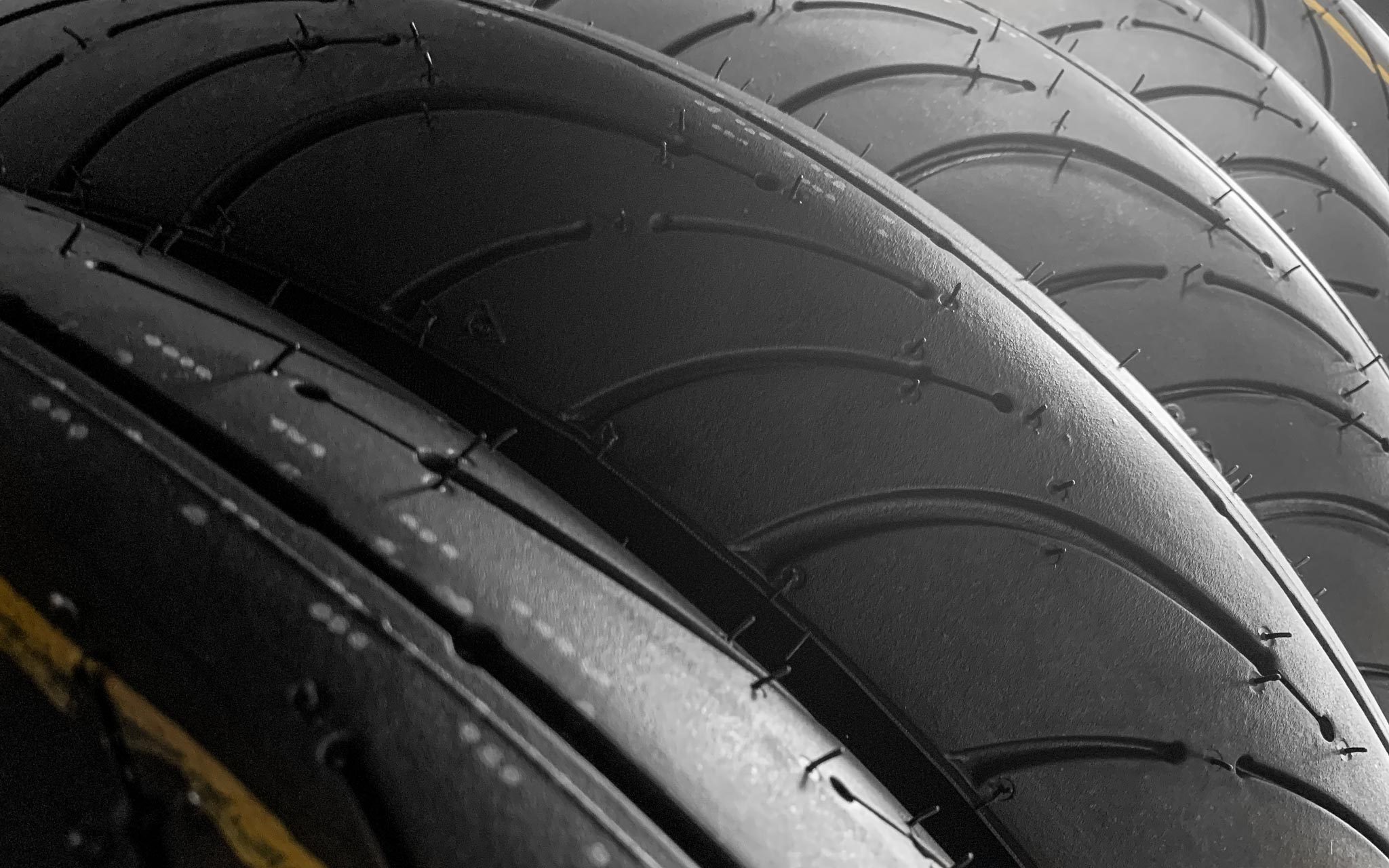 Close up of motorcycle tire treads lined up at an angle