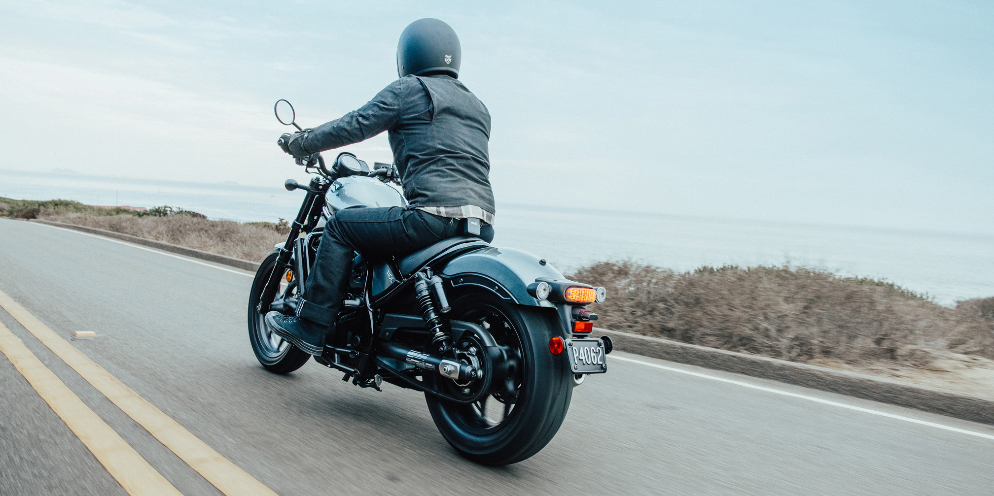 Lifestyle of rider on motorcycle riding away on highway